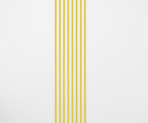 An installation of white gummed paper tape, 8 strips, floor to ceiling, that have a strand of yellow ribbon within each strip.