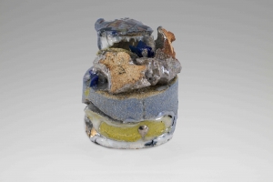 A small multicolor stone sculpture with blue, green, and orange tones, silver luster