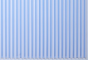 A photograph of blue ribbon hanging in a straight line on a wall