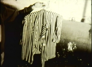 A screenshot of a black and white shirt held up on a hanger