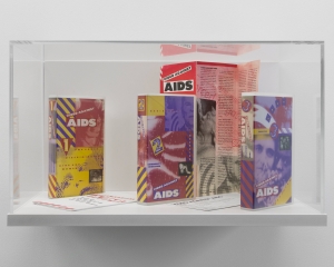 A vitrine that contains 2 tapes and a program for the "Video Against AIDS" program