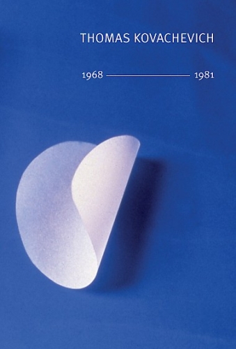 The front cover of "Thomas Kovachevich, 1968–1981," a photograph of a folded circle of tracing paper upon a blue background
