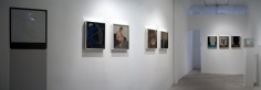 A panoramic image of the gallery that depicts 4 works on the left wall, 3 works on the back wall, and one sculpture at back-right