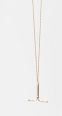 An image of an IUD made of brass, strung on a gold chain 