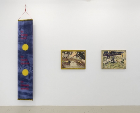 An installation view of works by Crystal Z. Campbell including a textile banner and and 2 mixed media paintings on wood panel