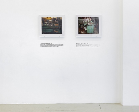 An installation view of 2 photographs by Jiri Skala of factory machines