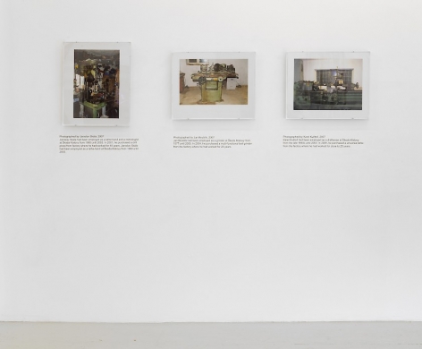 An installation view of 3 photographs by Jiri Skala of factory machines