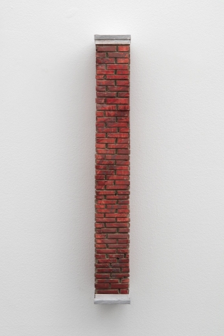 A sculpted brick column, installed on the wall.