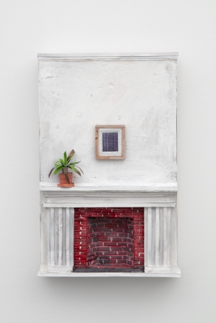 A sculpture of a white wall and a white mantle, with a brick fireplace that is red. There is a plant on the mantel, and a small drawing, also by Buffon, on the wall. The whole sculpture is installed on the wall.