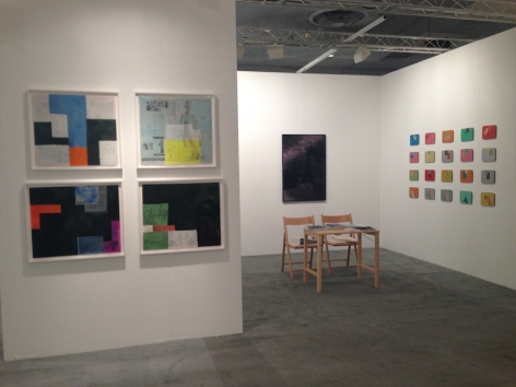 A view of the booth with 4 Sadie Benning works on the exterior, and a desk in the center of the booth