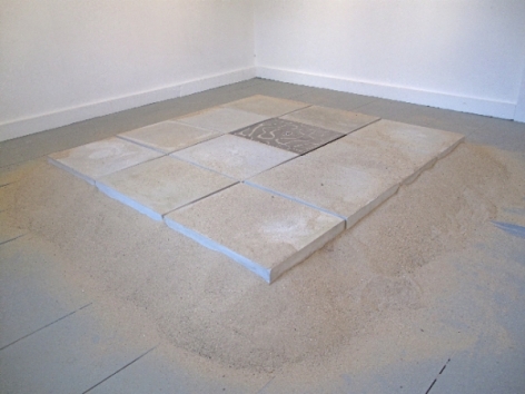 A site specific installation of 12 tiles on a bed of sand