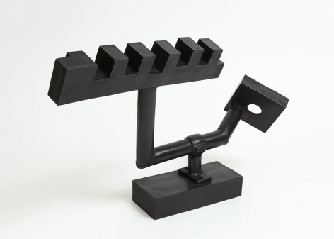 A black sculpture holding 2 parts in juxtaposition: a square with a hole in it, and a rectangle with open joints