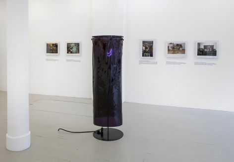 Installation view of a sculpture by Ajay Kurian and 5 photographs by Jiri Skala of factory machines