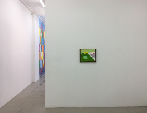 Installation view of an Etel Adnan painting on a wall in the foreground, with a sight-line that leads to the next room and Colter Jacobsen's painting