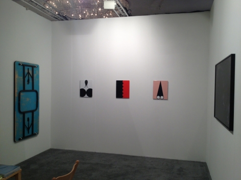 A view of the inside of the booth, with 3 enamel paintings on the far wall, and one Tongue Depressor by James Hoff