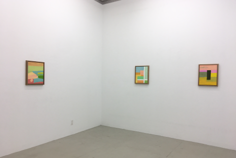 An installation view of 3 Etel Adnan paintings, framed in pine wood