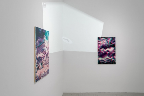 A detail of two artworks situated around the corner. Here we see a video projected onto the gallery wall and paintings. The video is a projection of the interior of the gallery itself.