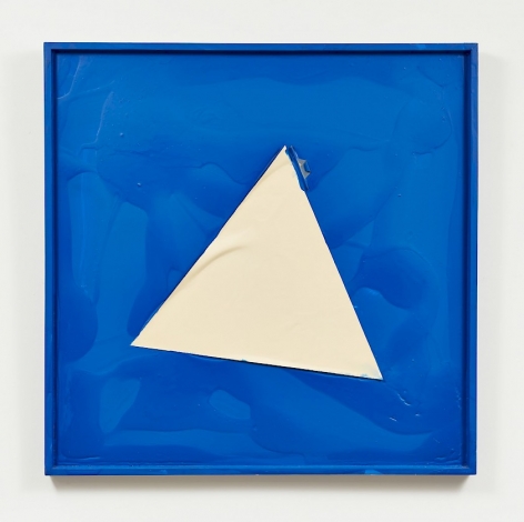 A blue square ground framed in blue. In the center of the blue is a triangle made of paper, with a small wrinkle at the left side. There are pools of blue paint that take on a physical form.